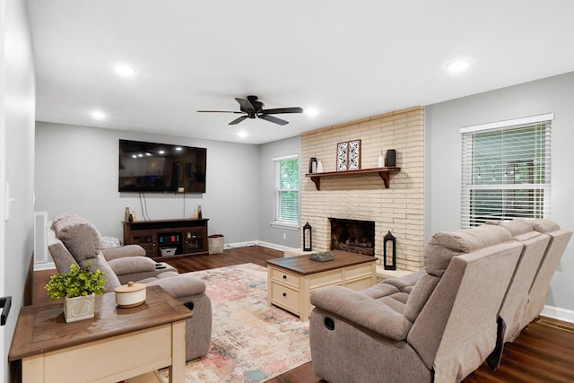living area with a ceiling fan, a fireplace, visible vents, dark wood-style flooring, and recessed lighting