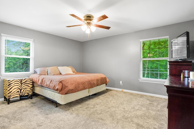 bedroom with ceiling fan, carpet, and baseboards