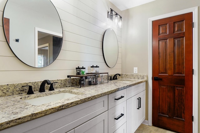 bathroom featuring double vanity and a sink
