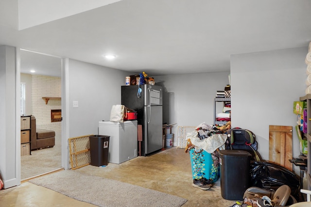below grade area featuring freestanding refrigerator and refrigerator