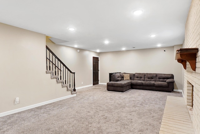 living area featuring carpet flooring, recessed lighting, a brick fireplace, baseboards, and stairs
