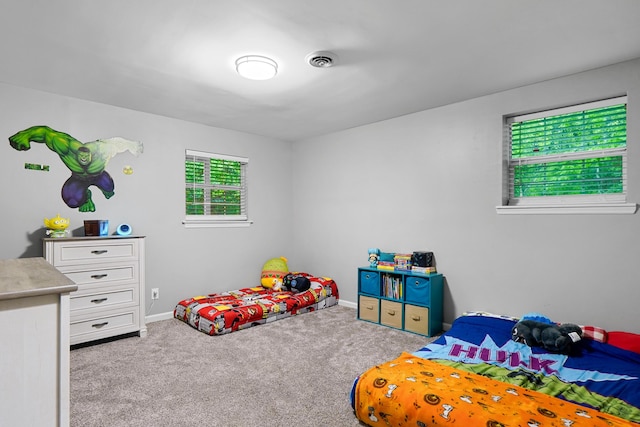 carpeted bedroom featuring baseboards