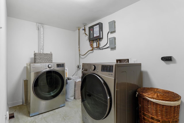 laundry area with washing machine and dryer, laundry area, and marble finish floor