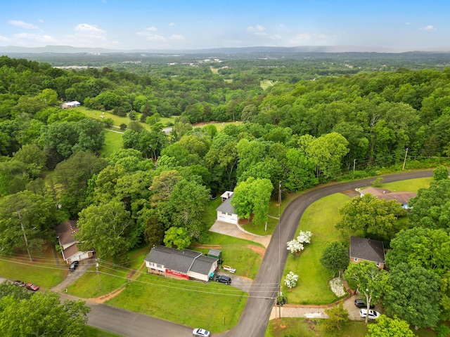 drone / aerial view featuring a forest view