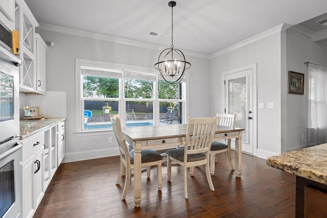 9726 Haven Port Ln, Ooltewah, TN 37363 - dining area featuring baseboards, an inviting chandelier, crown molding, and dark wood-type flooring