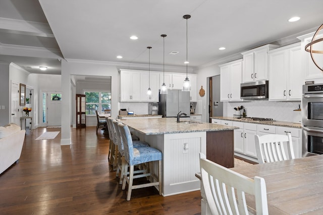 9726 Haven Port Ln, Ooltewah, TN 37363 - kitchen featuring crown molding, decorative backsplash, appliances with stainless steel finishes, and a sink