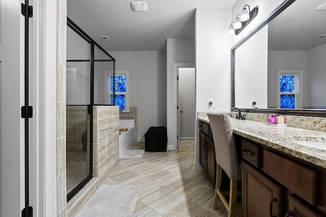 9726 Haven Port Ln, Ooltewah, TN 37363 - bathroom featuring double vanity, a stall shower, a garden tub, and baseboards