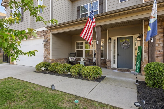 9726 Haven Port Ln, Ooltewah, TN 37363 - entrance to property with concrete driveway, stone siding, a porch, and a garage