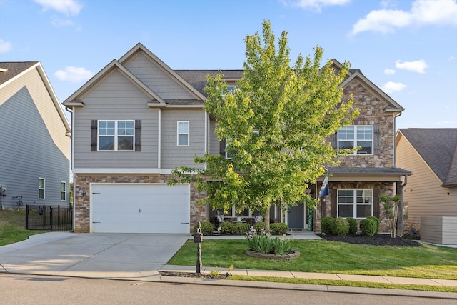 9726 Haven Port Ln, Ooltewah, TN 37363 - craftsman house featuring concrete driveway, an attached garage, stone siding, and a front yard