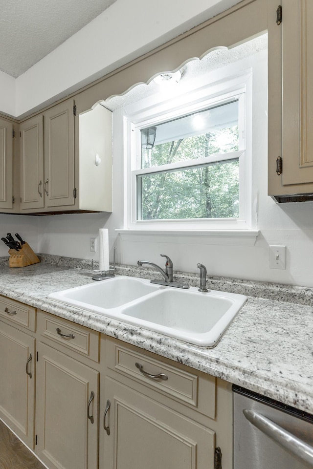 kitchen with a sink, light countertops, and dishwasher