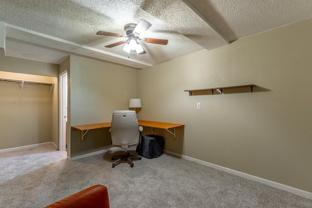 office featuring baseboards, ceiling fan, carpet, and a textured ceiling