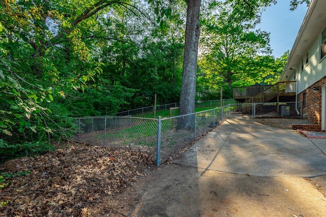 view of yard with fence, a deck, and stairway