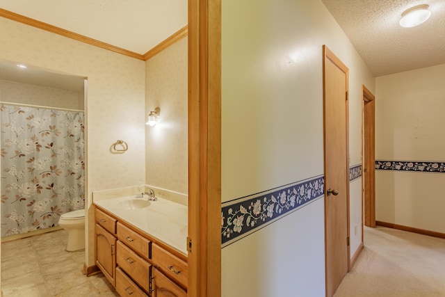 bathroom featuring vanity, crown molding, toilet, baseboards, and a textured ceiling