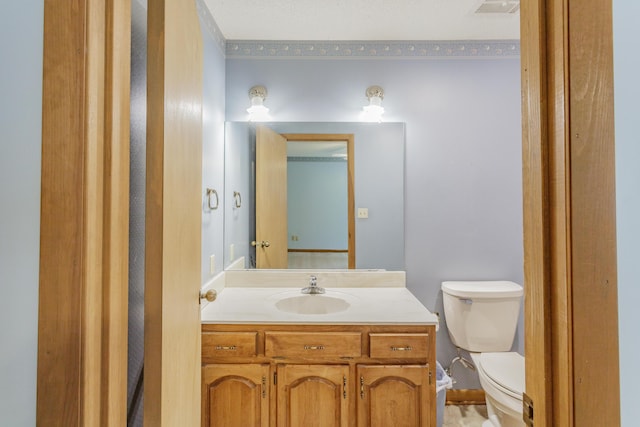 half bath featuring vanity, visible vents, and toilet