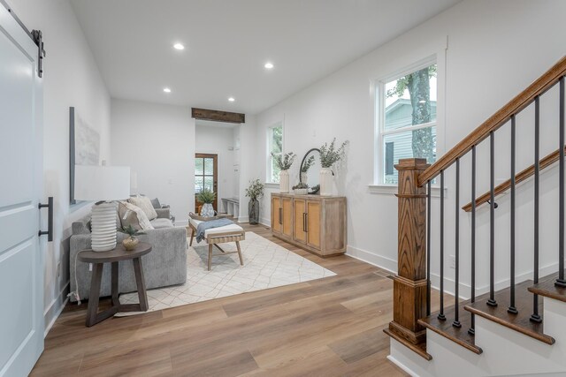 2111 Ivy St, Chattanooga, TN 37404 - living room with a healthy amount of sunlight, stairs, a barn door, and wood finished floors