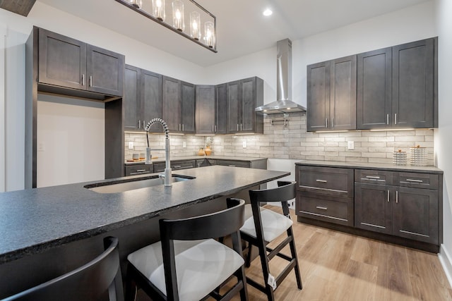 2111 Ivy St, Chattanooga, TN 37404 - kitchen featuring wall chimney range hood, backsplash, a kitchen bar, and a sink