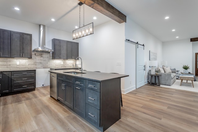 2111 Ivy St, Chattanooga, TN 37404 - kitchen with wall chimney range hood, a barn door, a sink, light wood finished floors, and stainless steel dishwasher