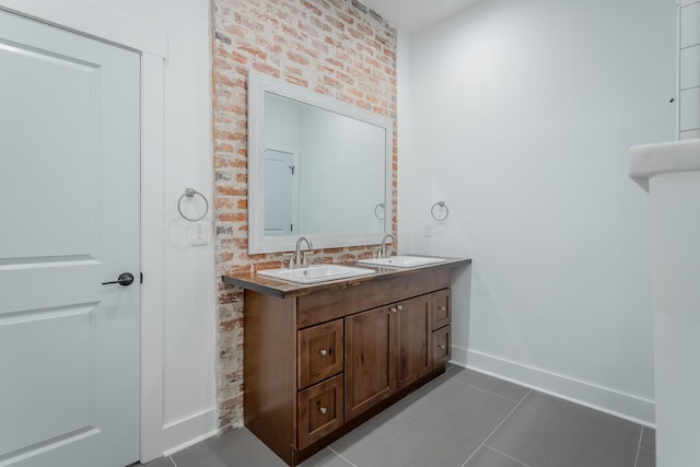 2111 Ivy St, Chattanooga, TN 37404 - bathroom with baseboards, a sink, tile patterned flooring, and double vanity