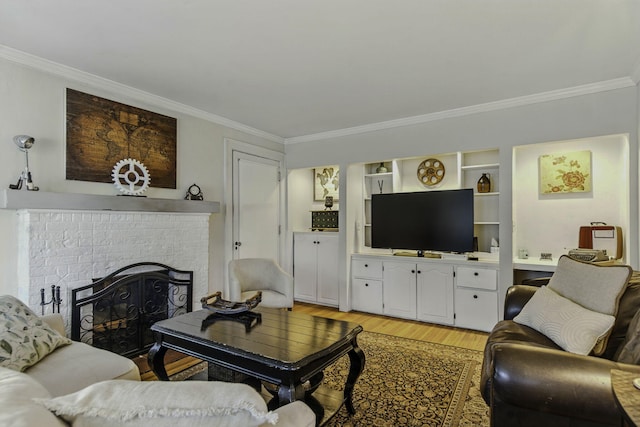 living room featuring light wood-style floors, ornamental molding, and a fireplace
