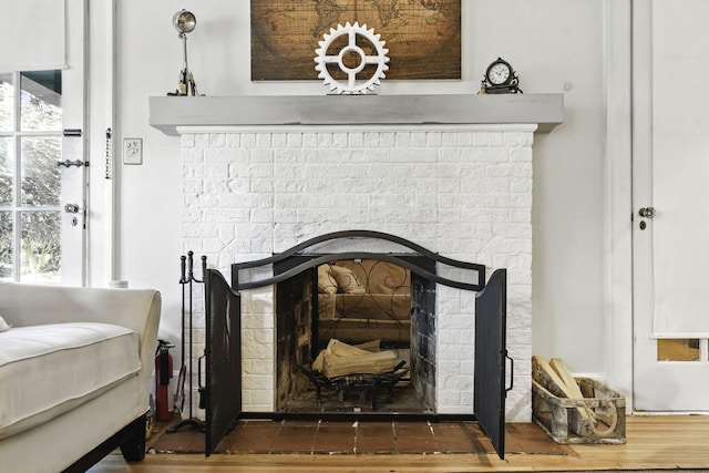 interior details featuring a brick fireplace