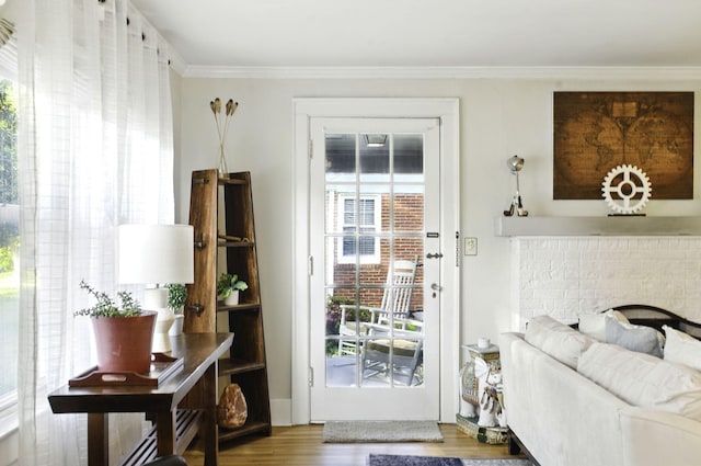 doorway featuring crown molding and wood finished floors