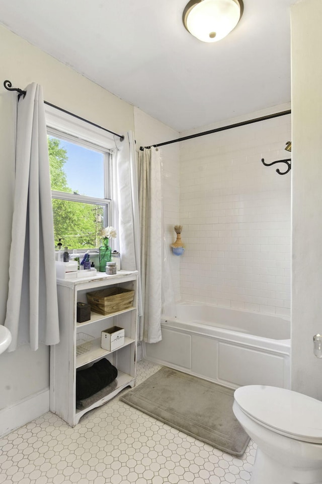 full bathroom featuring tile patterned flooring, shower / bath combination with curtain, and toilet