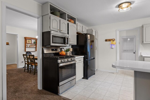 7403 Flagstone Dr, Ooltewah, TN 37363 - kitchen with light countertops, appliances with stainless steel finishes, and baseboards