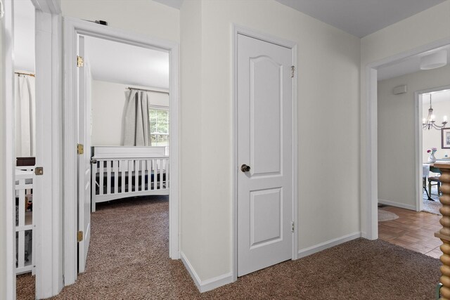 7403 Flagstone Dr, Ooltewah, TN 37363 - hallway featuring an inviting chandelier, baseboards, and carpet flooring