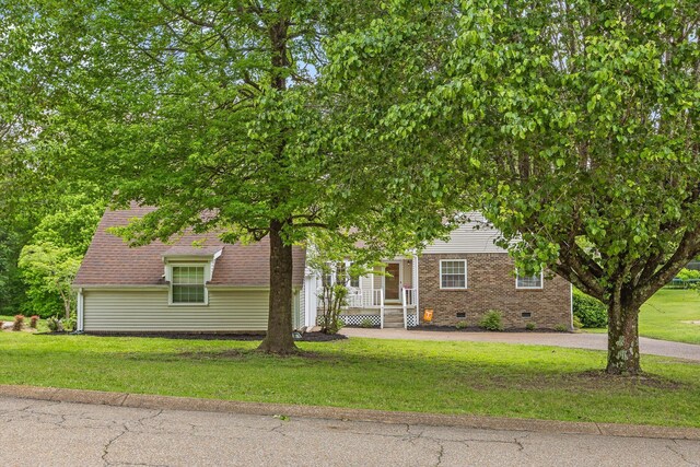 7403 Flagstone Dr, Ooltewah, TN 37363 - obstructed view of property with a front yard, brick siding, and crawl space