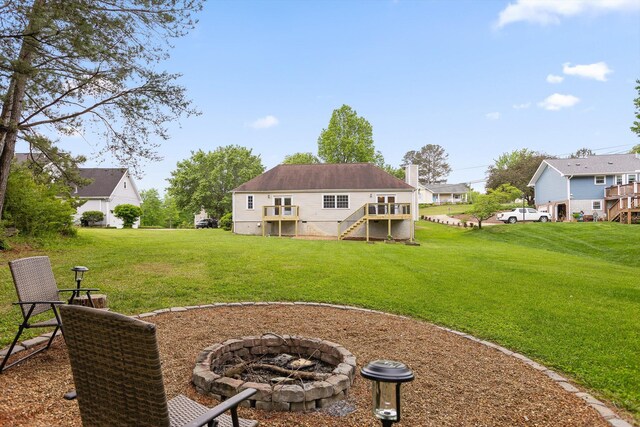 7403 Flagstone Dr, Ooltewah, TN 37363 - rear view of house featuring stairway, a yard, and an outdoor fire pit