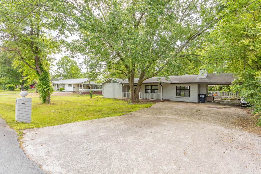 2008 Carol St, Rossville, GA 30741 - single story home with a front yard, a chimney, a porch, driveway, and a carport