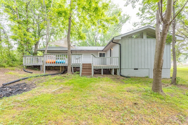 back of house featuring a wooden deck, a yard, and crawl space