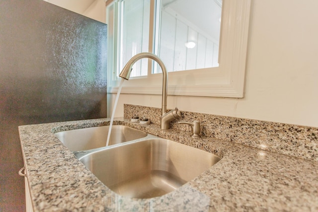 room details with a sink and light stone counters