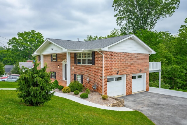split foyer home featuring a front yard, brick siding, aphalt driveway, an attached garage, and a shingled roof