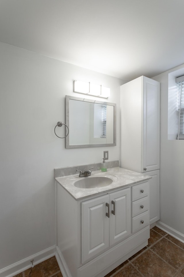 bathroom featuring baseboards and vanity