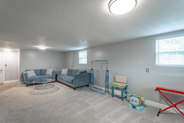 playroom with carpet floors, baseboards, a textured ceiling, and visible vents