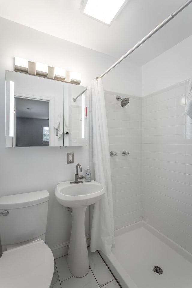 bathroom with toilet and a shower stall
