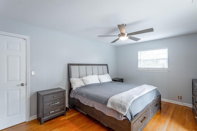 bedroom featuring baseboards, ceiling fan, and light wood-style floors