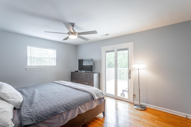bedroom with ceiling fan, access to exterior, baseboards, wood finished floors, and visible vents