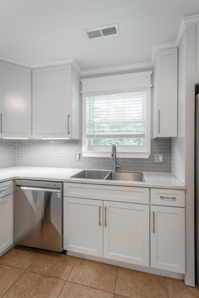 kitchen with a sink, light tile patterned floors, dishwasher, and white cabinets