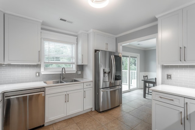 kitchen featuring light countertops, appliances with stainless steel finishes, plenty of natural light, and a sink