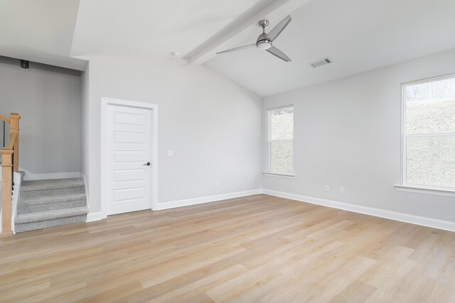 unfurnished room featuring stairway, light wood-type flooring, and healthy amount of natural light