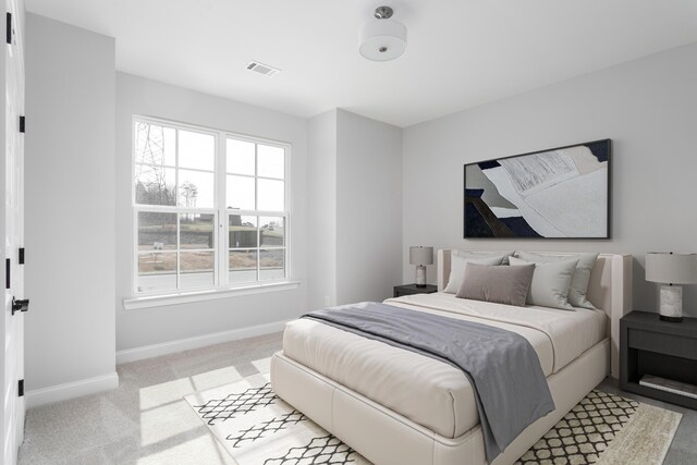 bedroom featuring baseboards and light carpet
