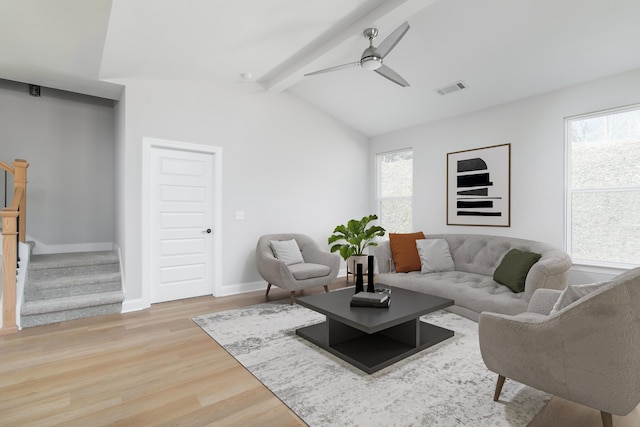 living area featuring light wood-style floors, healthy amount of natural light, stairs, and a ceiling fan