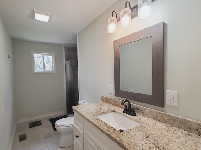 bathroom featuring toilet, vanity, visible vents, tile patterned floors, and baseboards