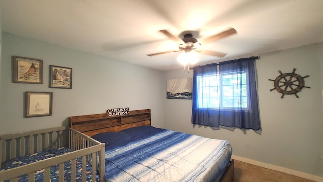 carpeted bedroom with baseboards and a ceiling fan