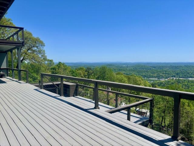 wooden deck with a forest view