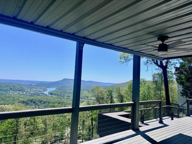 wooden deck with a mountain view and ceiling fan