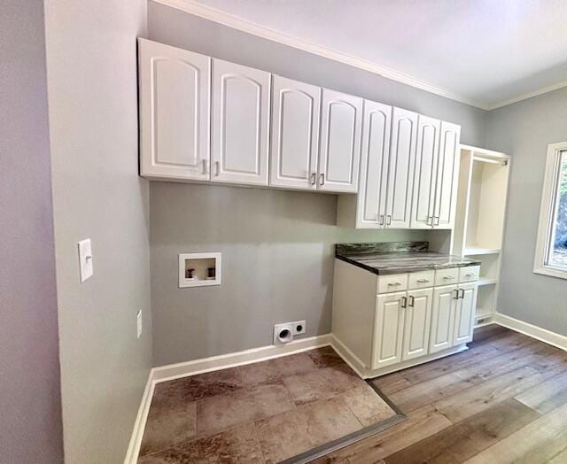 laundry room with washer hookup, hookup for an electric dryer, crown molding, cabinet space, and baseboards