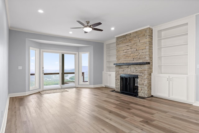 1206 Lower Brow Rd, Signal Mountain, TN 37377 - unfurnished living room with baseboards, ceiling fan, built in features, light wood-type flooring, and a stone fireplace